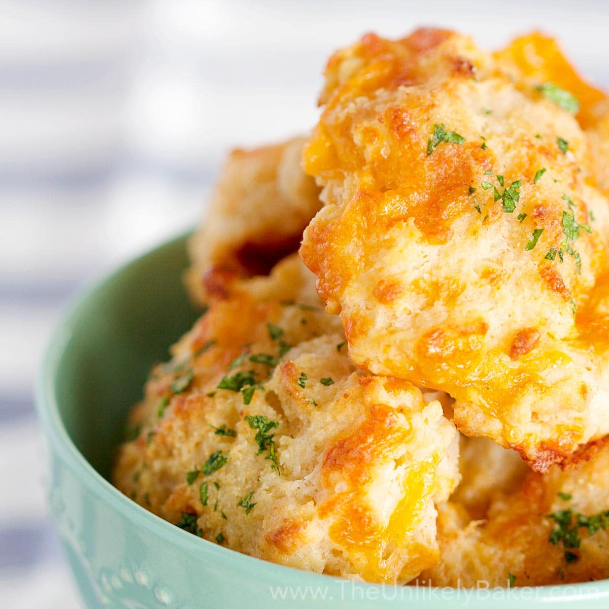 https://theunlikelybaker.com/wp-content/uploads/2016/05/Easy-Cheddar-Biscuits-FB.jpg