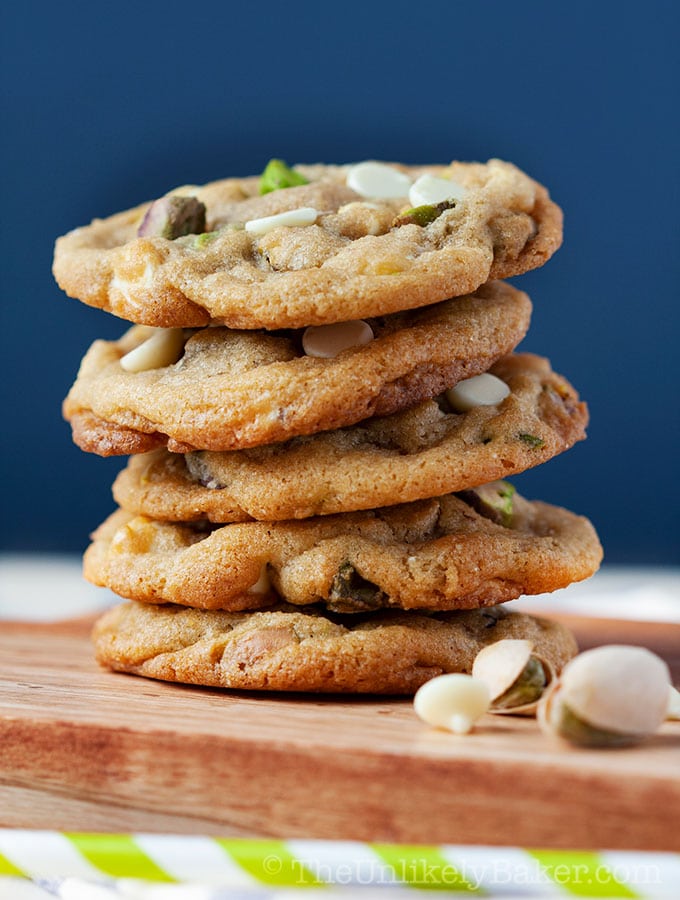 A stack of pistachio cookies with white chocolate chips.