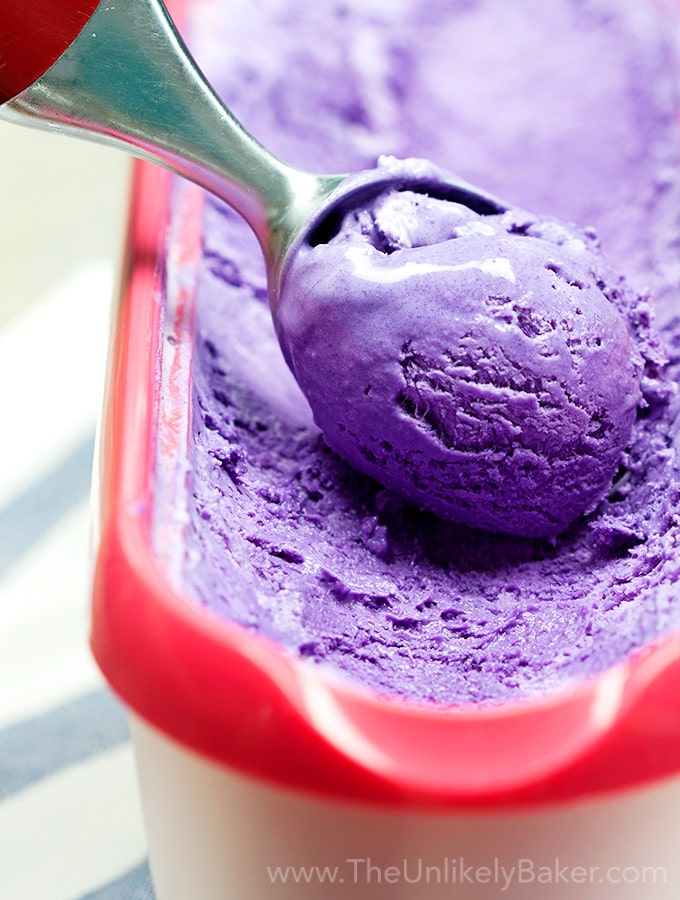 Ube ice cream scoop in a tub.