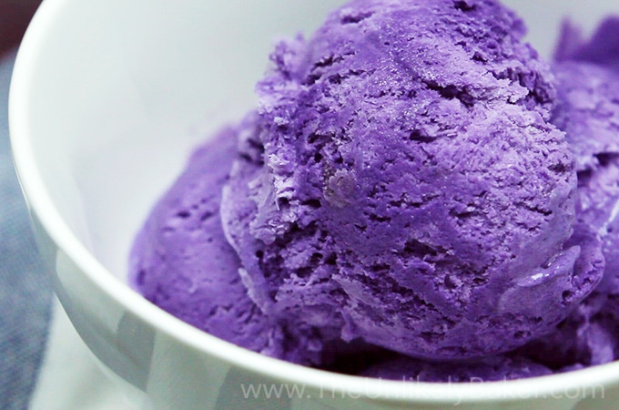 Close up shot of ube ice cream in a white bowl.