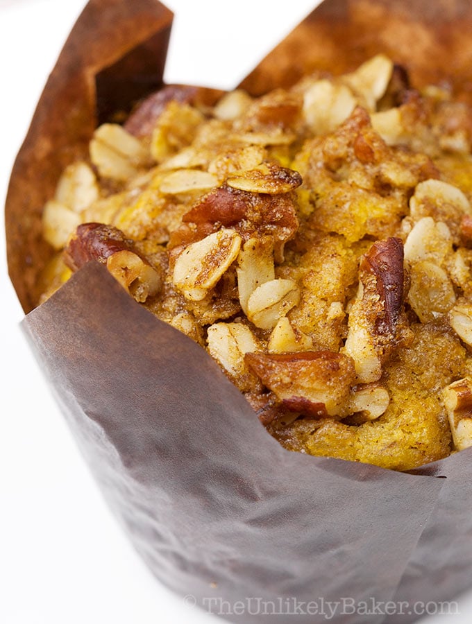 Closeup shot of a pumpkin pecan muffins that shows the pecan streusel topping.