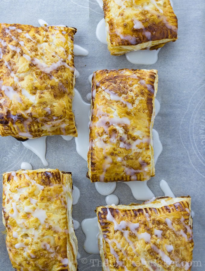 Puff Pastry Cherry Hand Pies on a Baking Sheet.