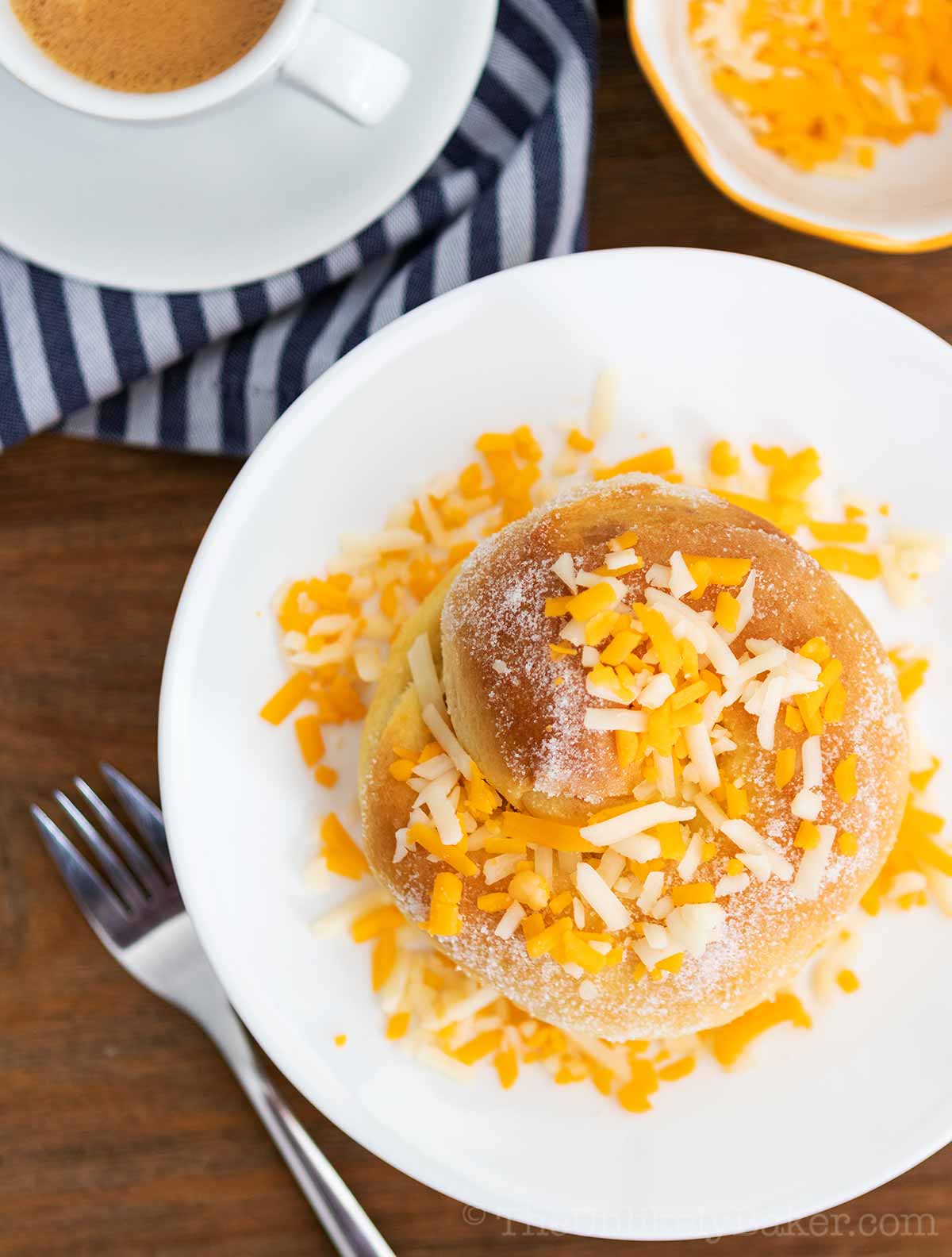 Soft and fluffy ensaymada on a white plate