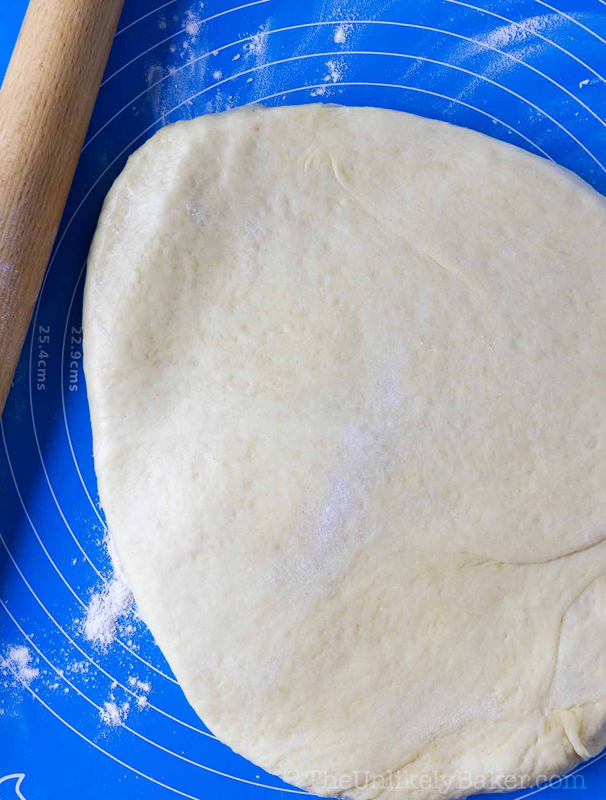 Bread dough slightly flattened with a rolling pin.