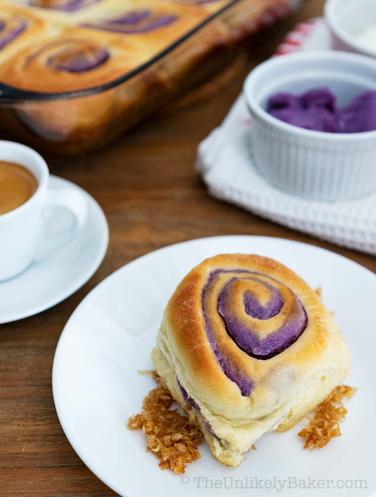 Ube bread on a plate with toasted coconut and coffee.