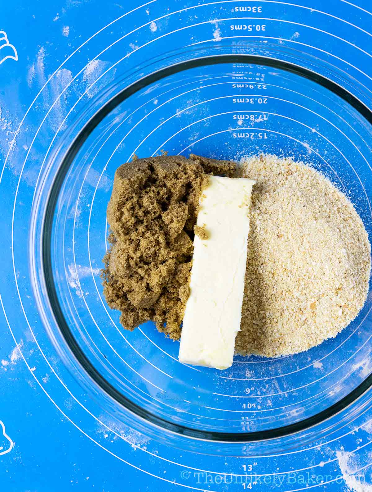 Ingredients for Spanish bread filling in a bowl - butter, breadcrumbs, brown sugar, milk.