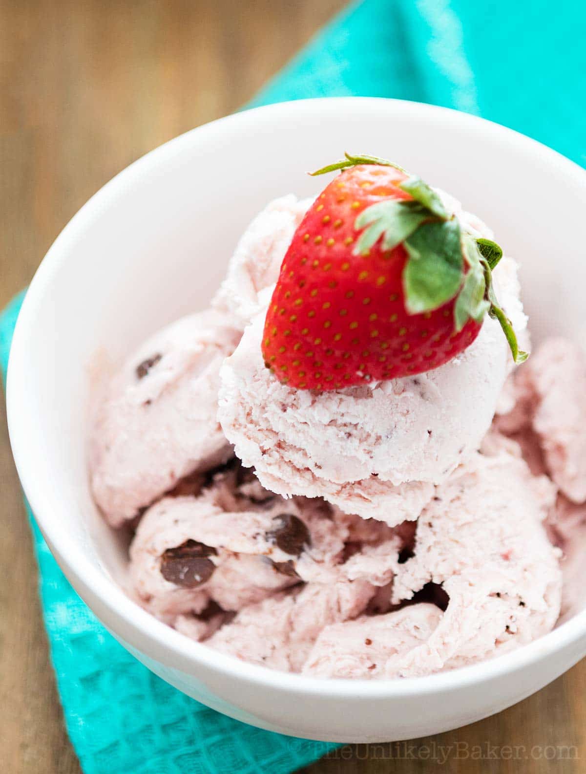 Strawberry ice cream with chocolate chips in a bowl.