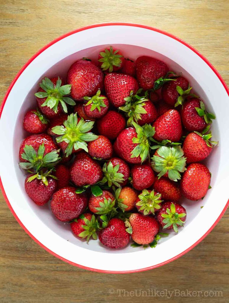 Fresh strawberries in a bowl of water