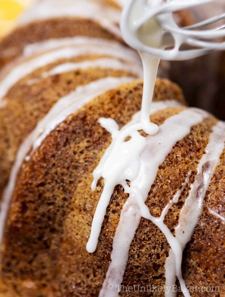 lemon glaze drizzling on a lemon bundt cake