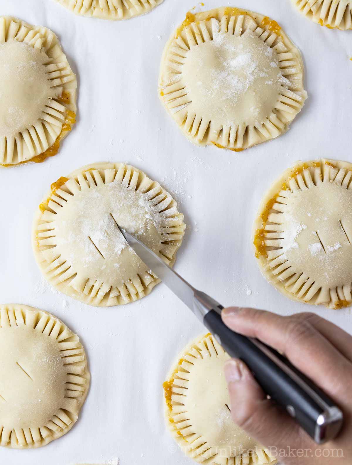 Cut the top of the pies to release air while baking.