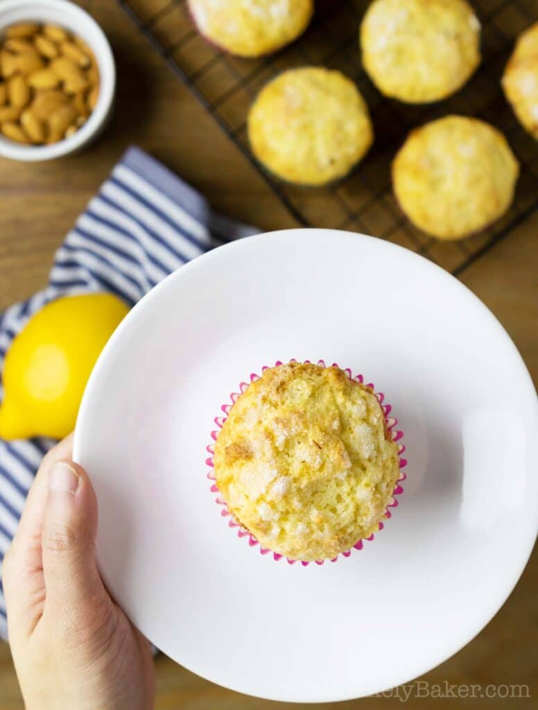 Freshly baked lemon ricotta muffin on a plate.