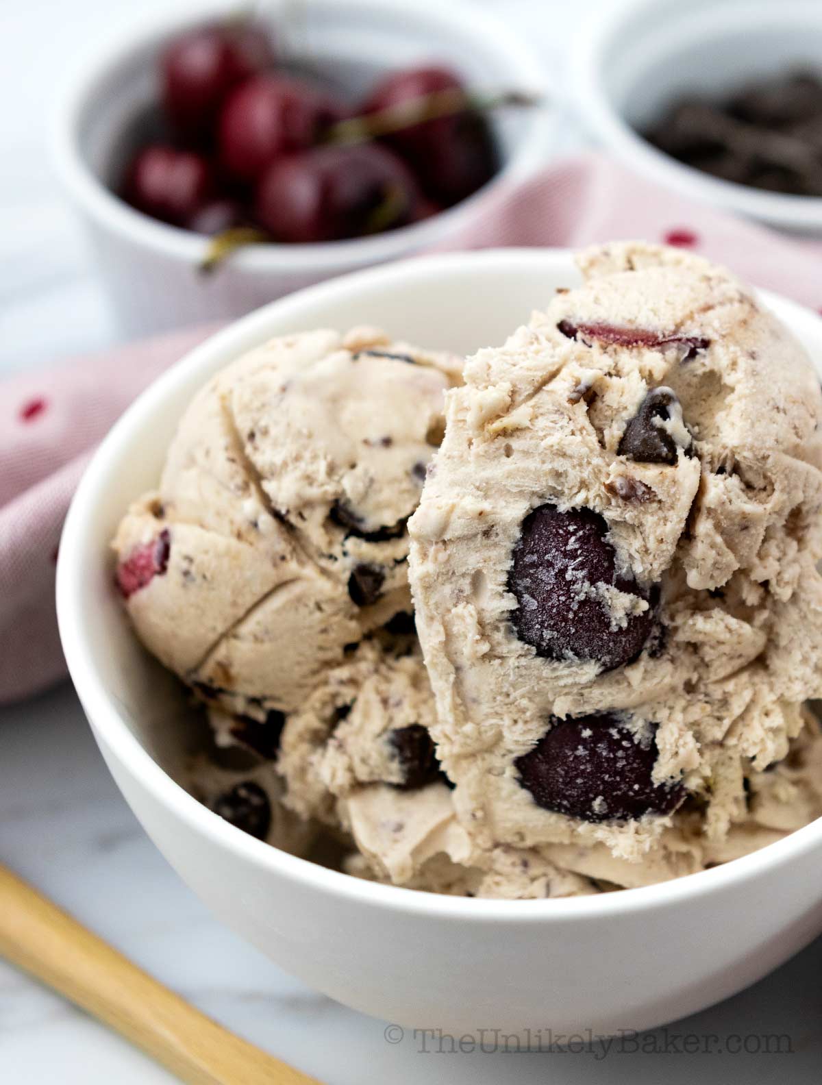 Scoop of chocolate cherry ice cream in a bowl.