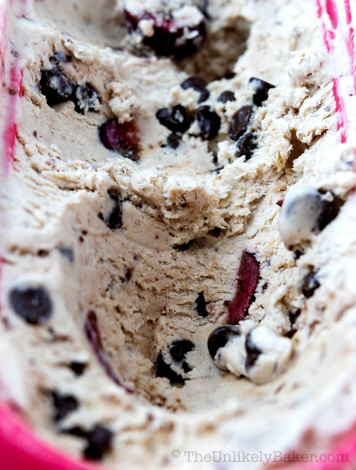 Homemade cherry chocolate chip ice cream in a tub.