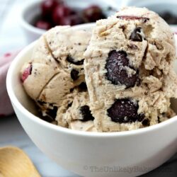 Scoop of cherry chocolate chip ice cream in a bowl.