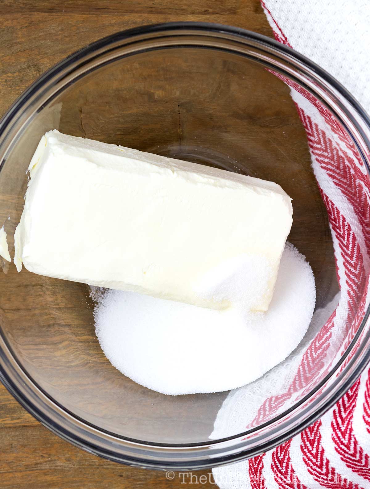 Cream cheese and sugar in a bowl.