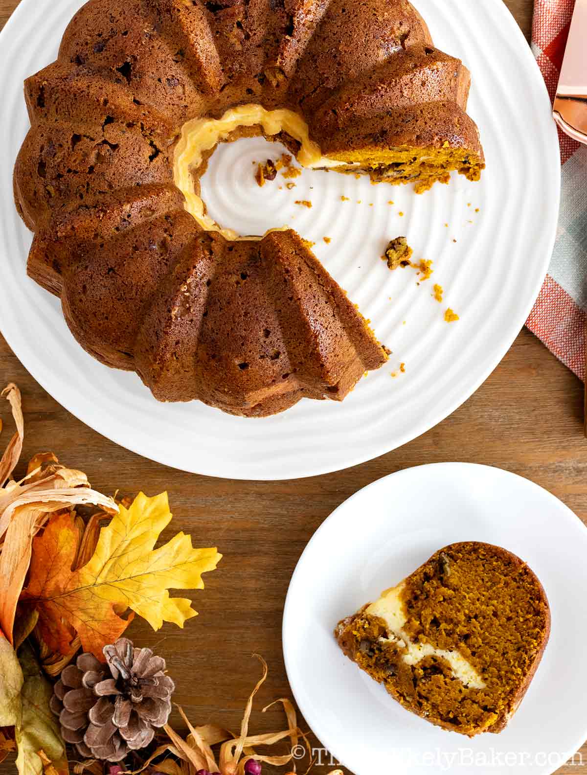 Overhead shot of a slice of cream cheese filled pumpkin bundt cake on a plate.
