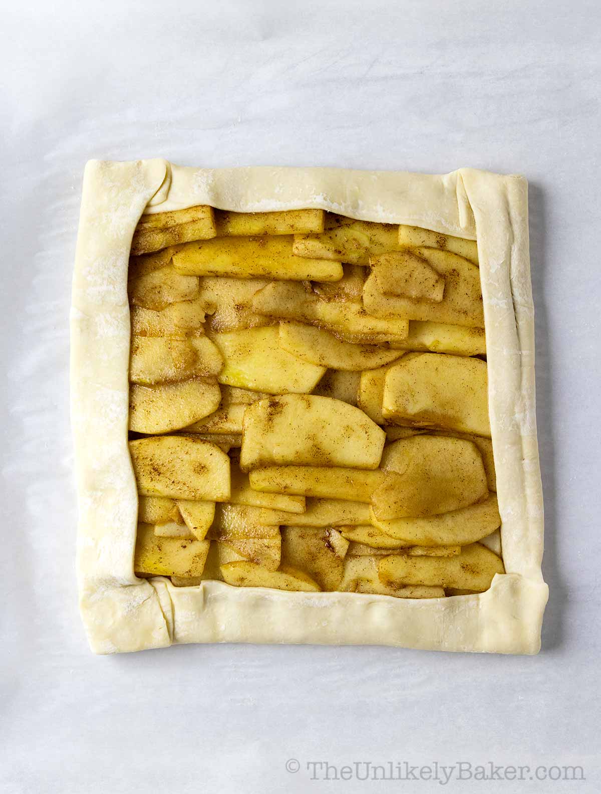 Fold puff pastry over apple slices