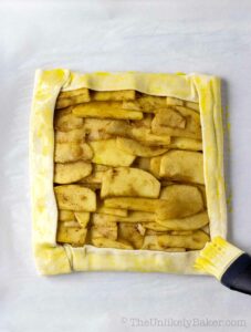 Brush apple galette puff pastry with egg wash