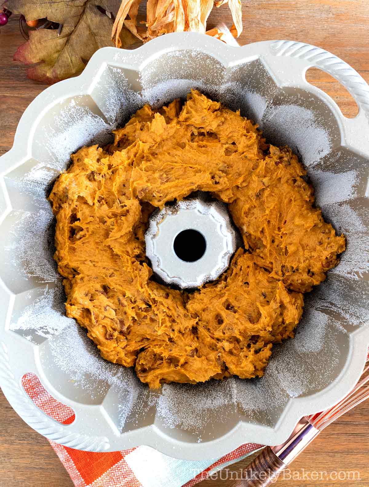 Transfer pumpkin cake batter to prepared pan