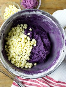 Add white chocolate chips to ube cookie dough