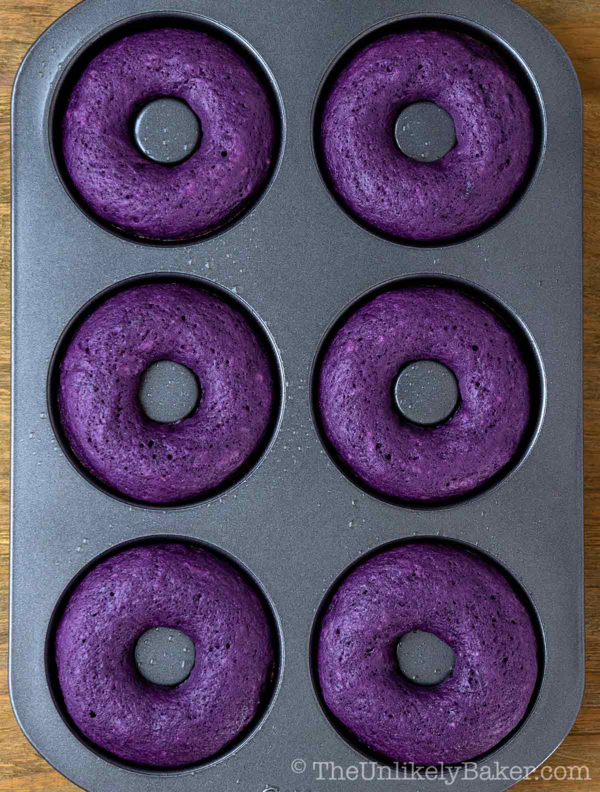 Freshly baked ube donuts in pan