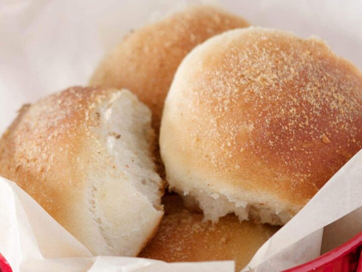 Freshly baked pandesal in a red tin