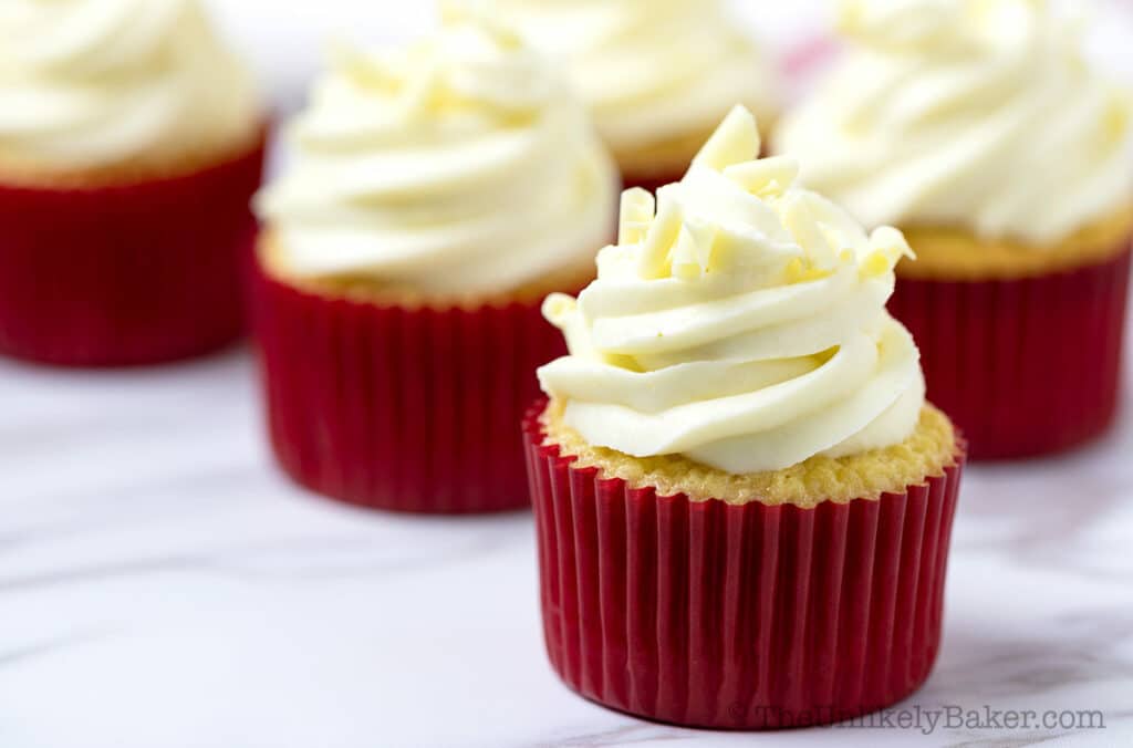 Group shot of white chocolate cupcakes with raspberry filling