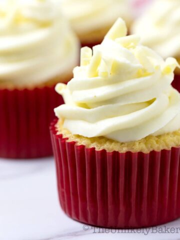 Close up shot of white chocolate cupcake with raspberry filling