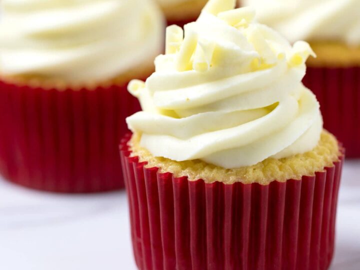 Close up shot of white chocolate cupcake with raspberry filling