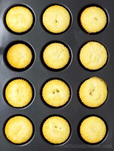 Freshly baked white chocolate cupcakes in baking pan