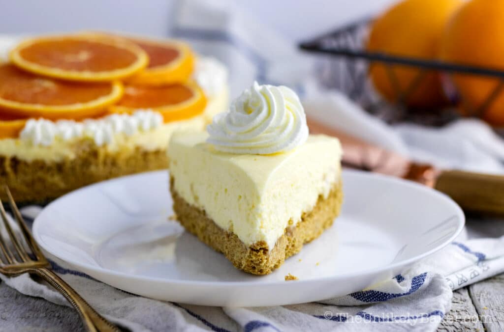 slice of orange cream cheesecake on a plate
