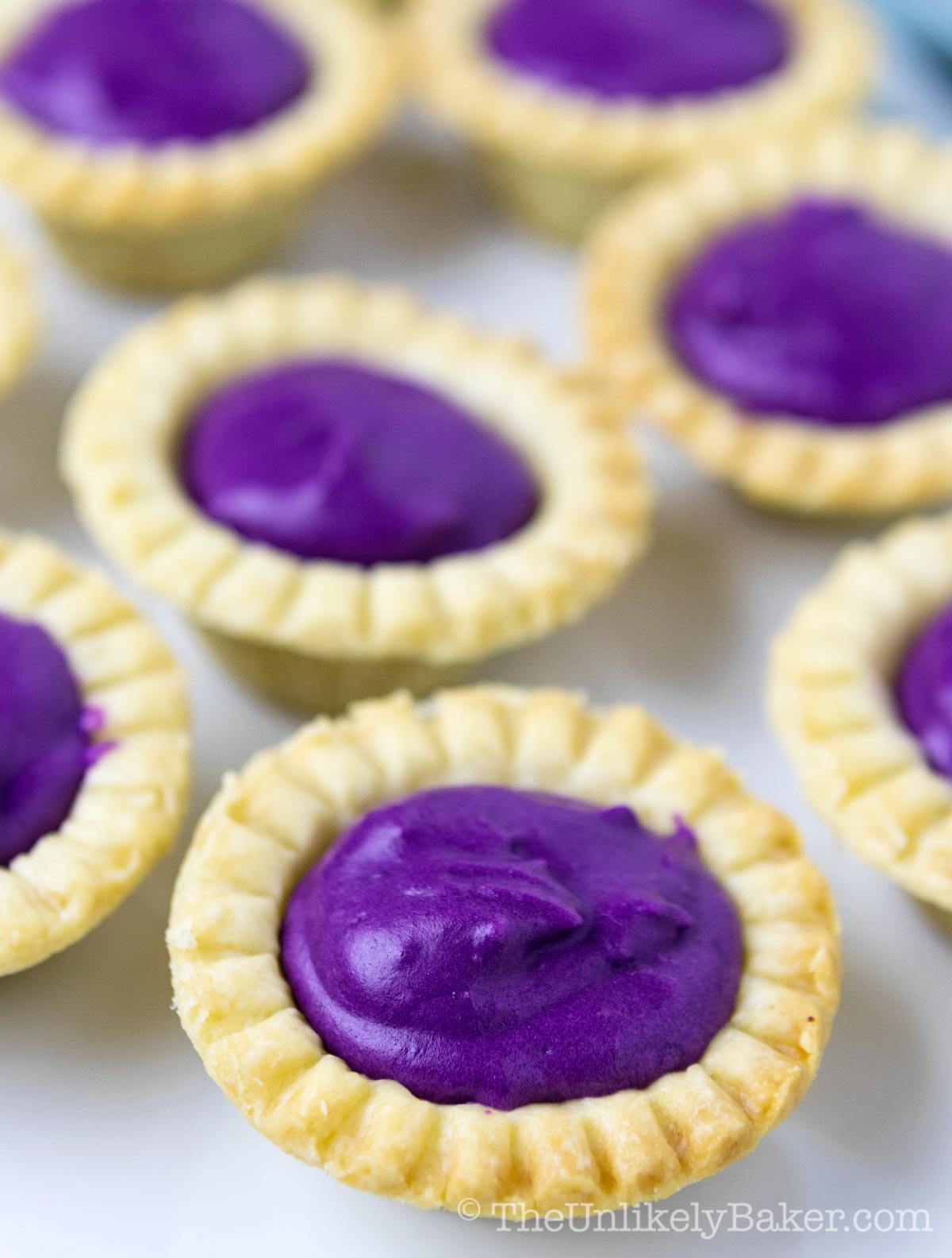 Ube tarts with shortbread crust on a plate.