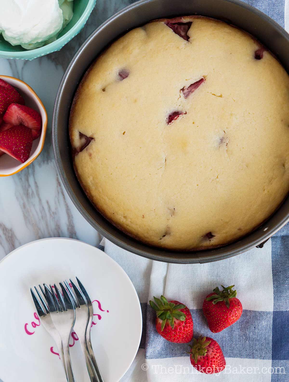 Freshly baked strawberry and ricotta cake in a pan.