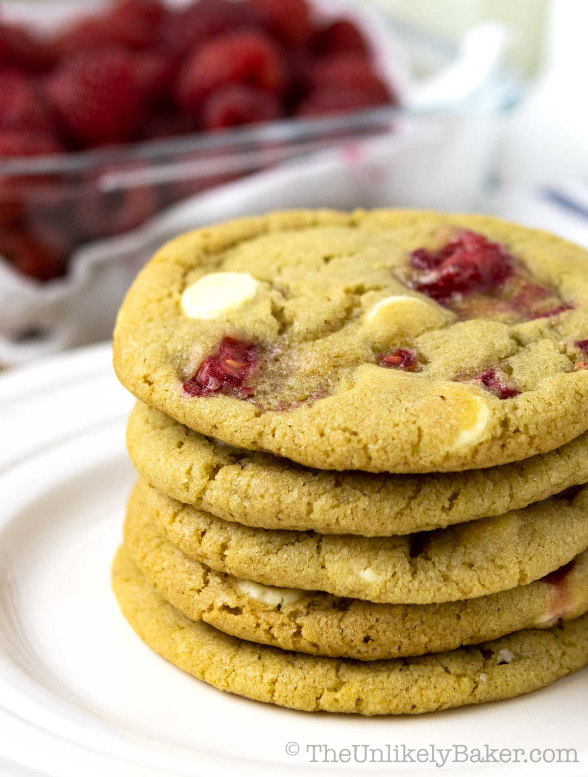 Soft and chewy white chocolate and raspberry cookies on a plate.