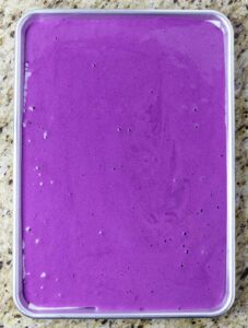 Ube roll cake batter ready for the oven.