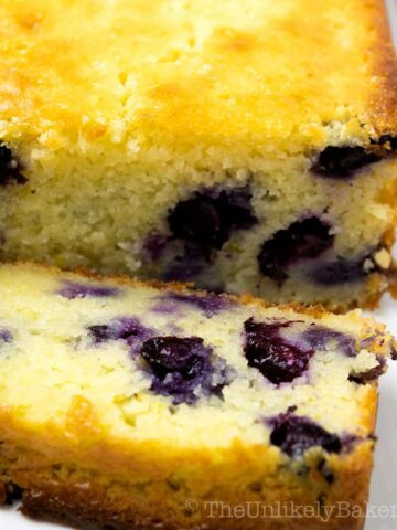 Photo of ricotta cake showing juicy blueberries within.