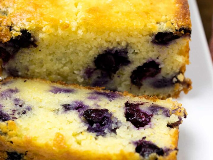 Photo of ricotta cake showing juicy blueberries within.