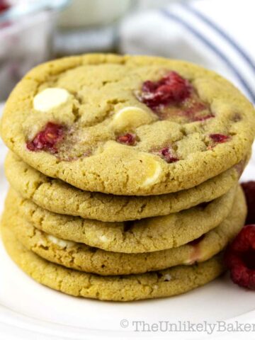 A stack of raspberry white chocolate cookies on a plate.