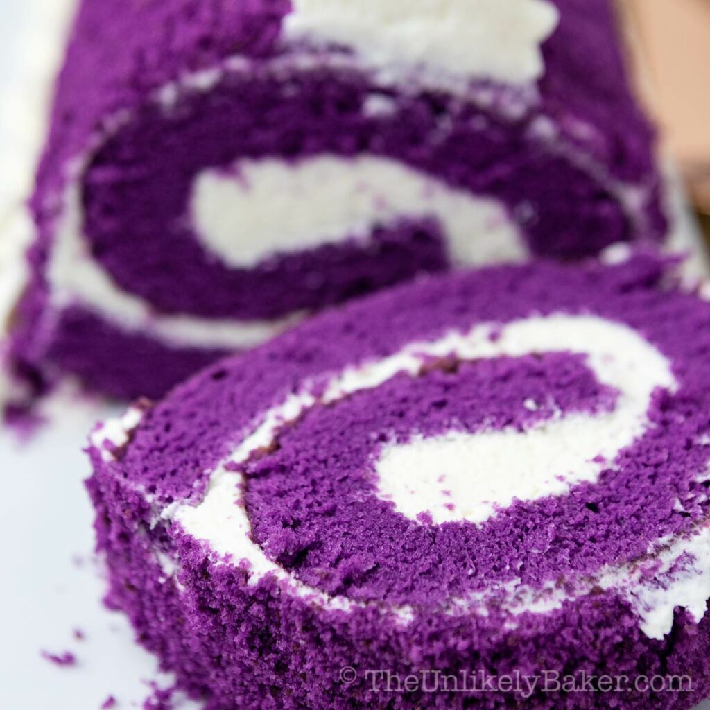 Close up shot of slice of ube roll cake.