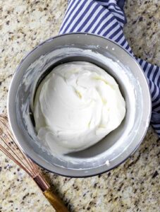 Freshly made whipped cream cheese frosting in a bowl.