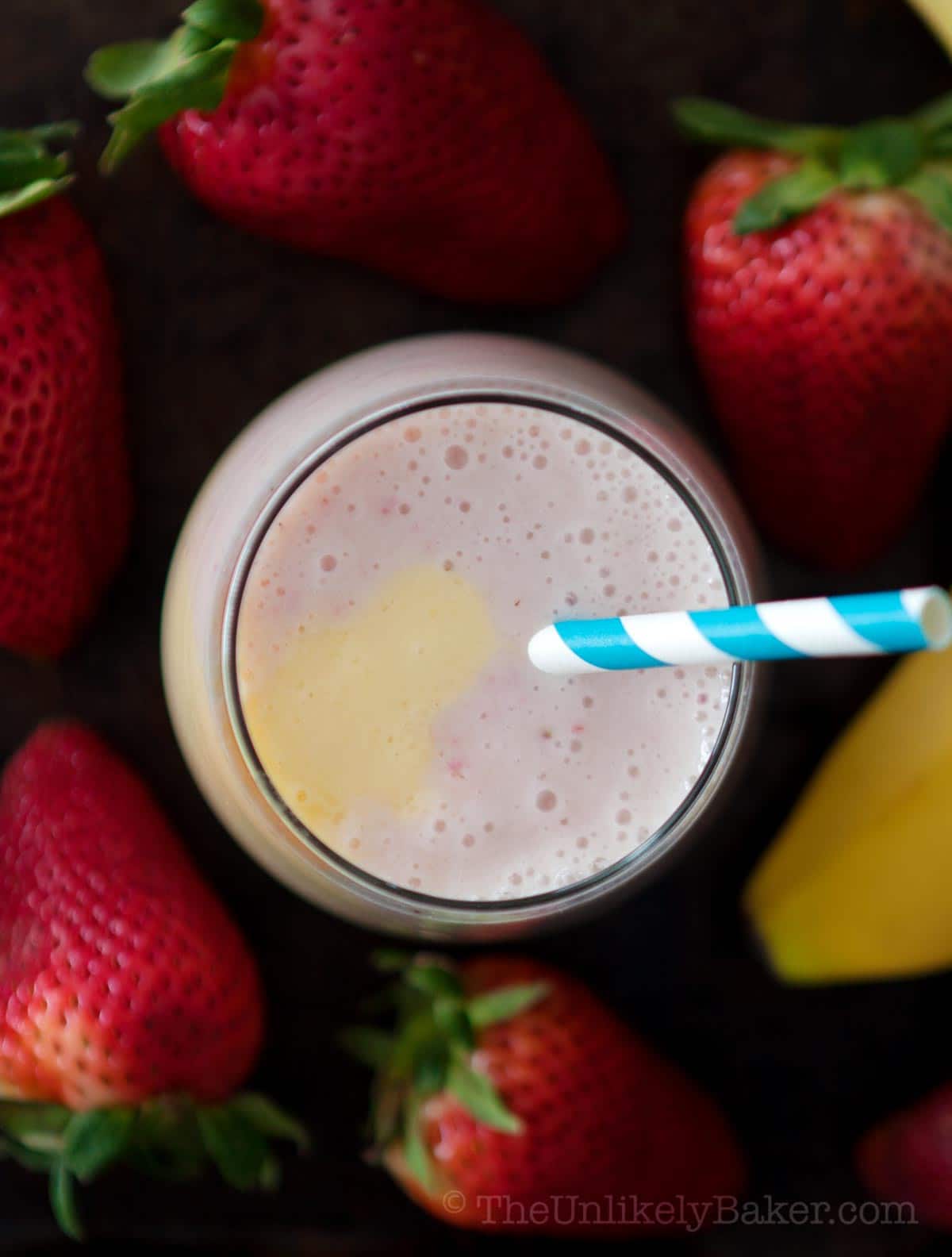 Refreshing strawberry mango banana smoothie in a glass.