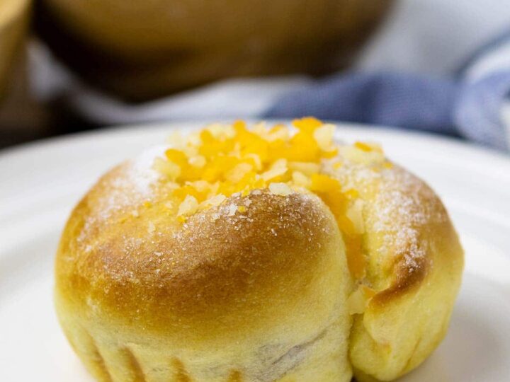 Fluffy ube ensaymada on a plate.