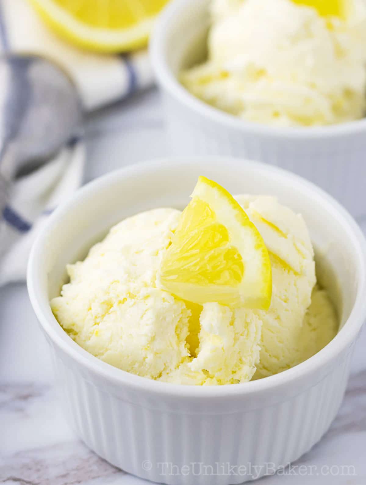 Several scoops of lemon ice cream in a white bowl.