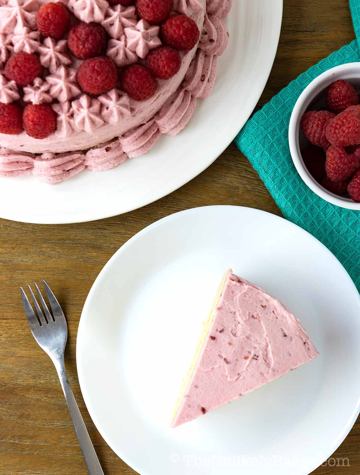 A slice of raspberry vanilla cake on a plate.