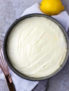 Lemon curd cheesecake in a pan ready to be chilled.
