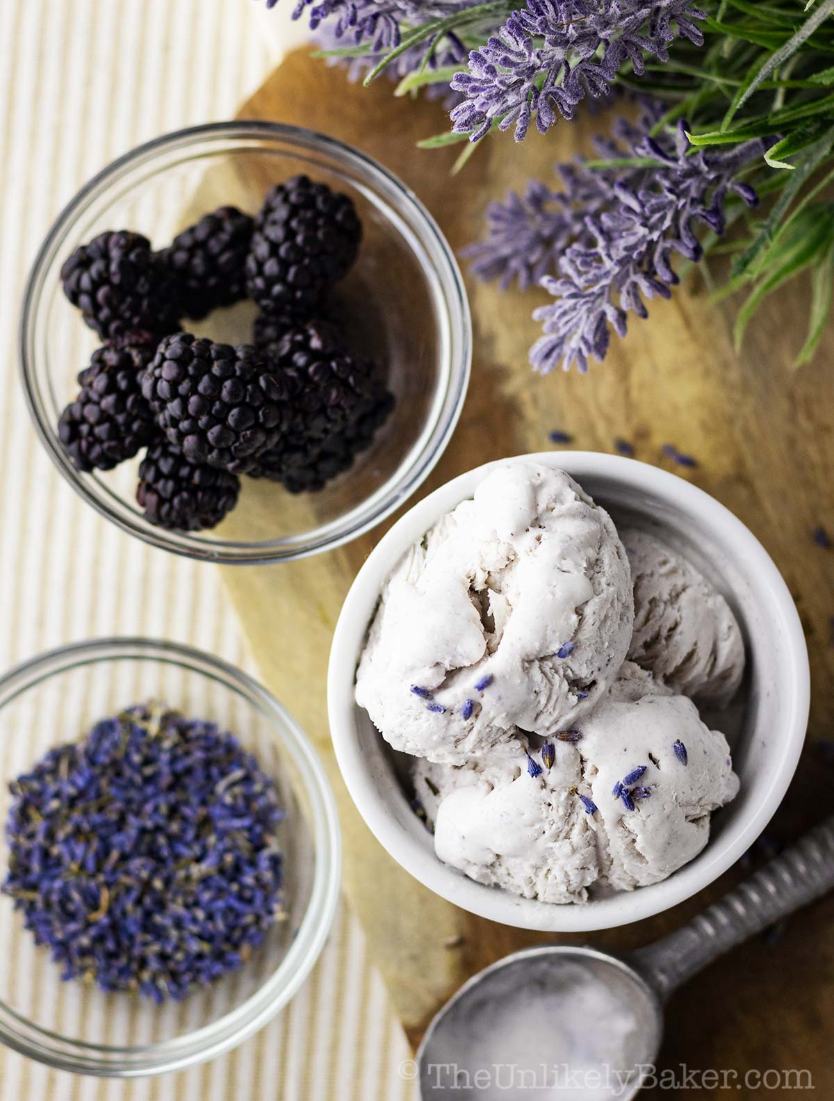 Overhead shot of lavender ice cream, blackberries and lavender buds.