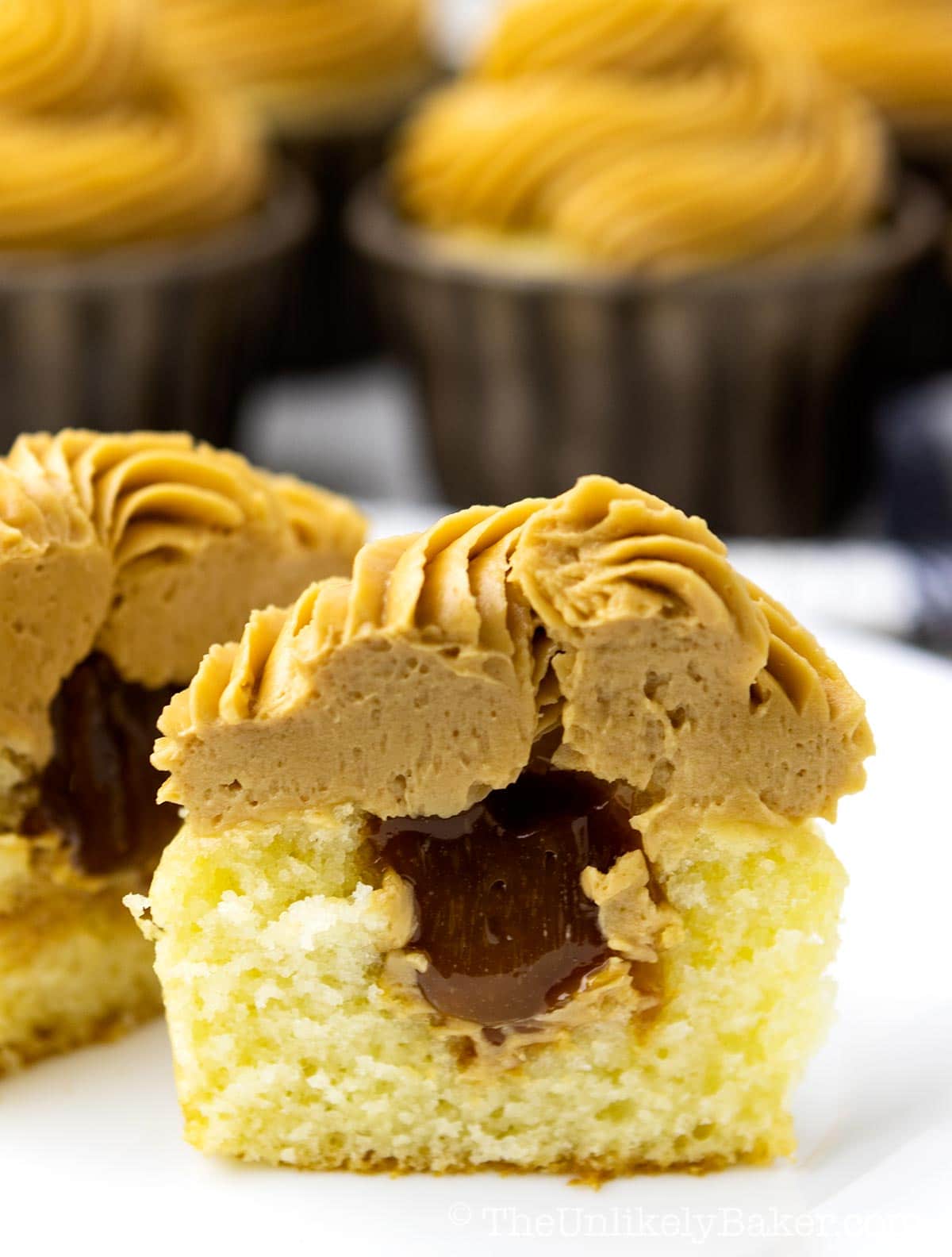 Dulce de leche filled cupcakes on a plate.