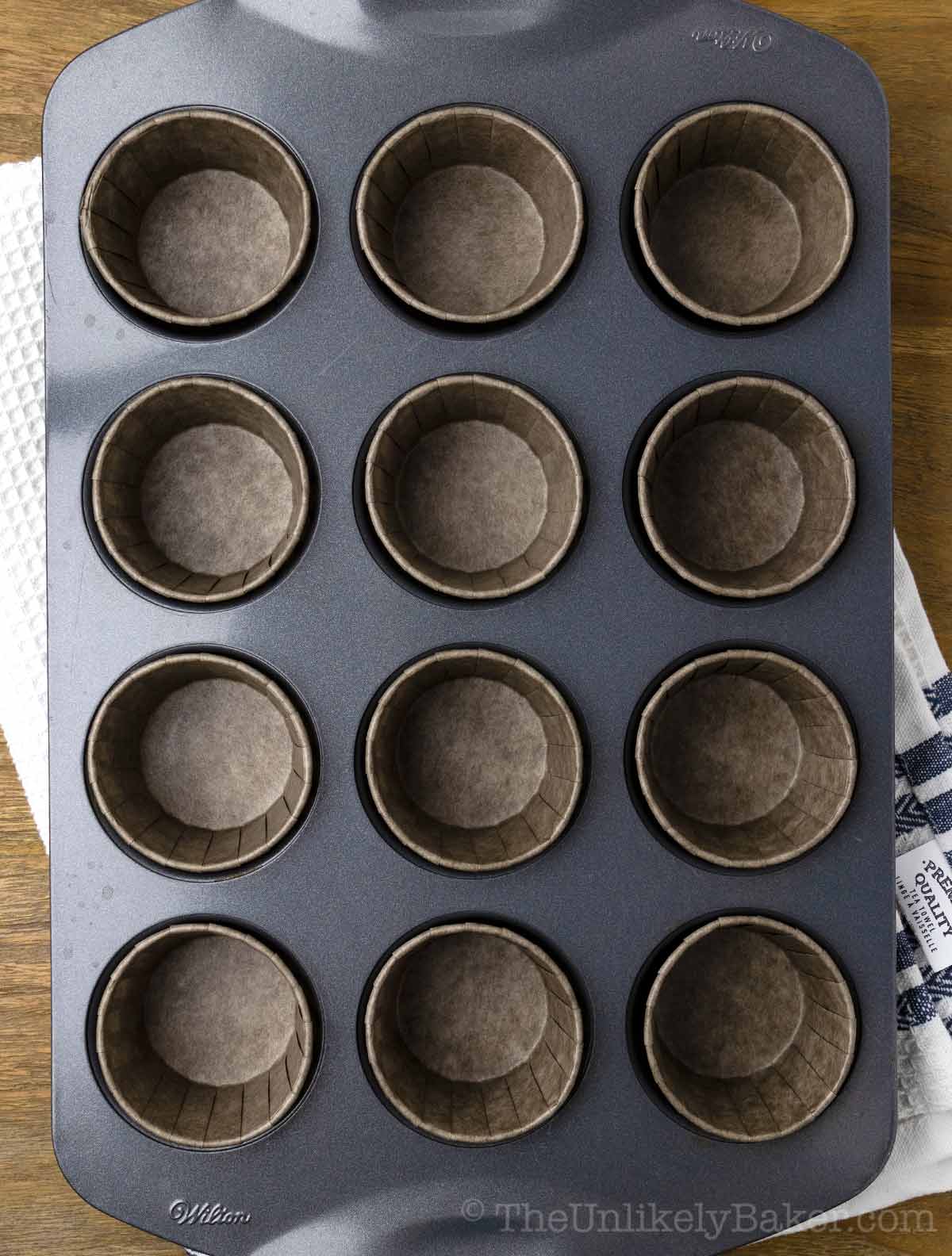 Cupcake pan lined with cupcake liners.