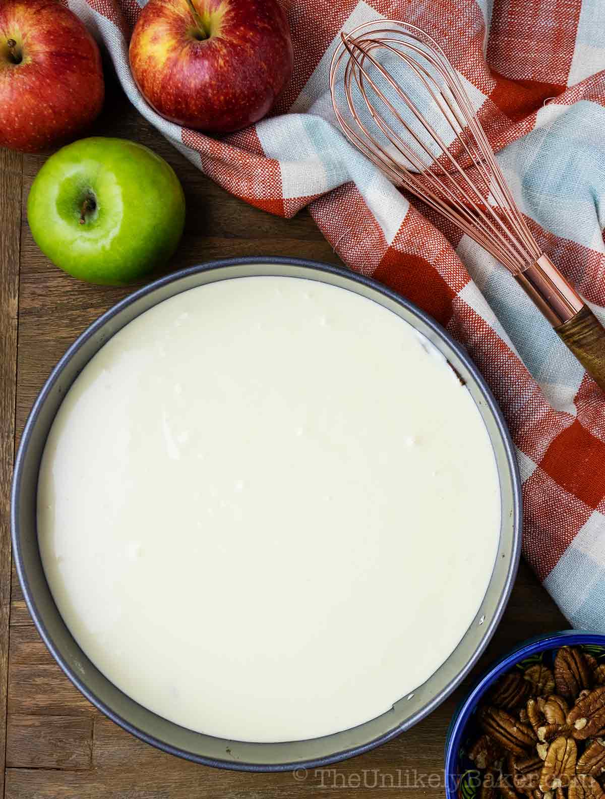 Apple cheesecake batter in pan.