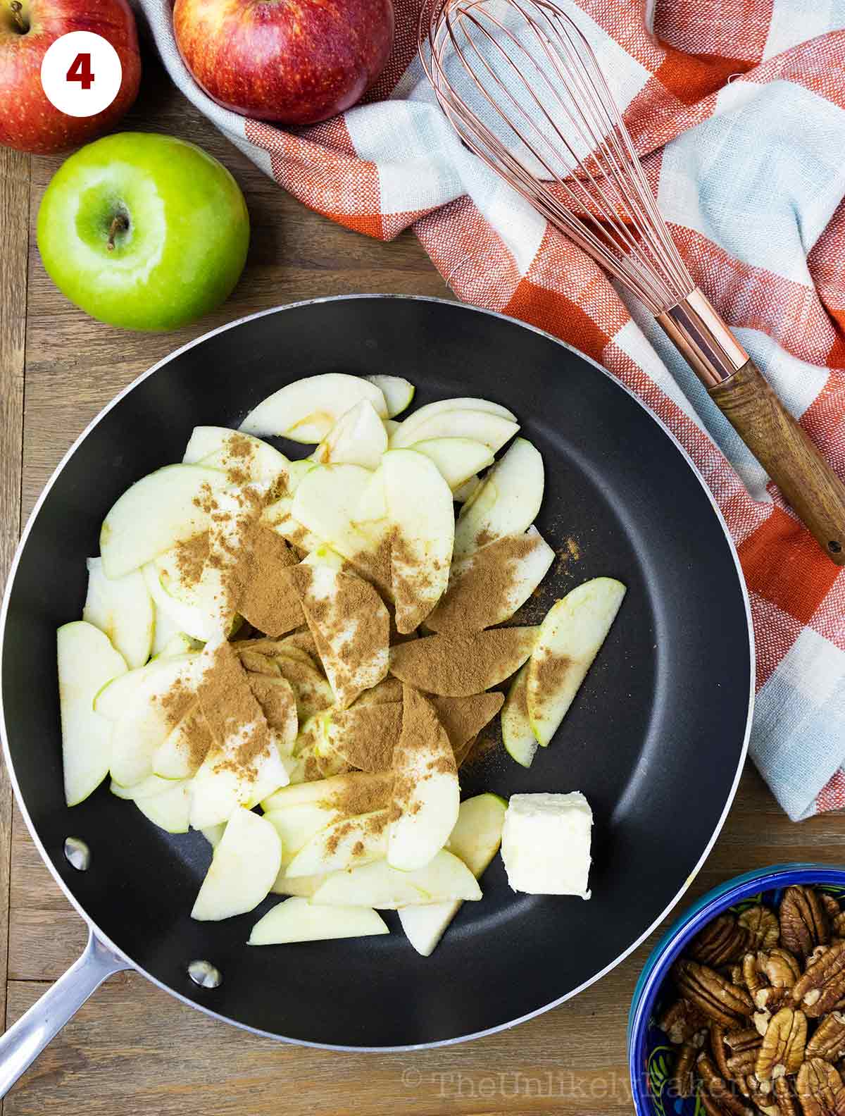 Sliced apples and cinnamon in a pan.